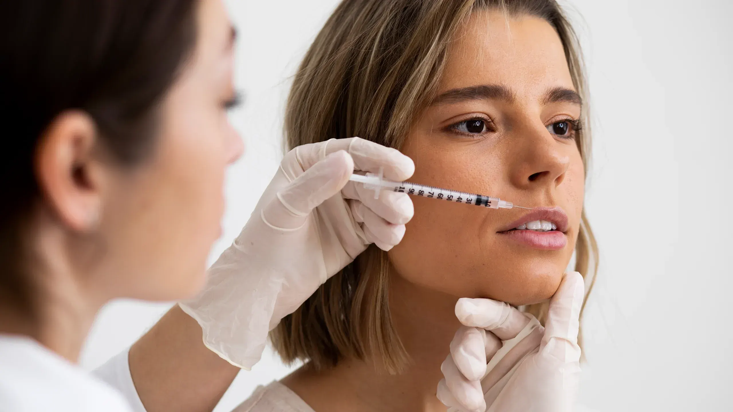 Patient discussing Xeomin and Dysport neurotoxin treatment options during a wrinkle consultation at Mint Aesthetics & Skin in Indianapolis, Indiana